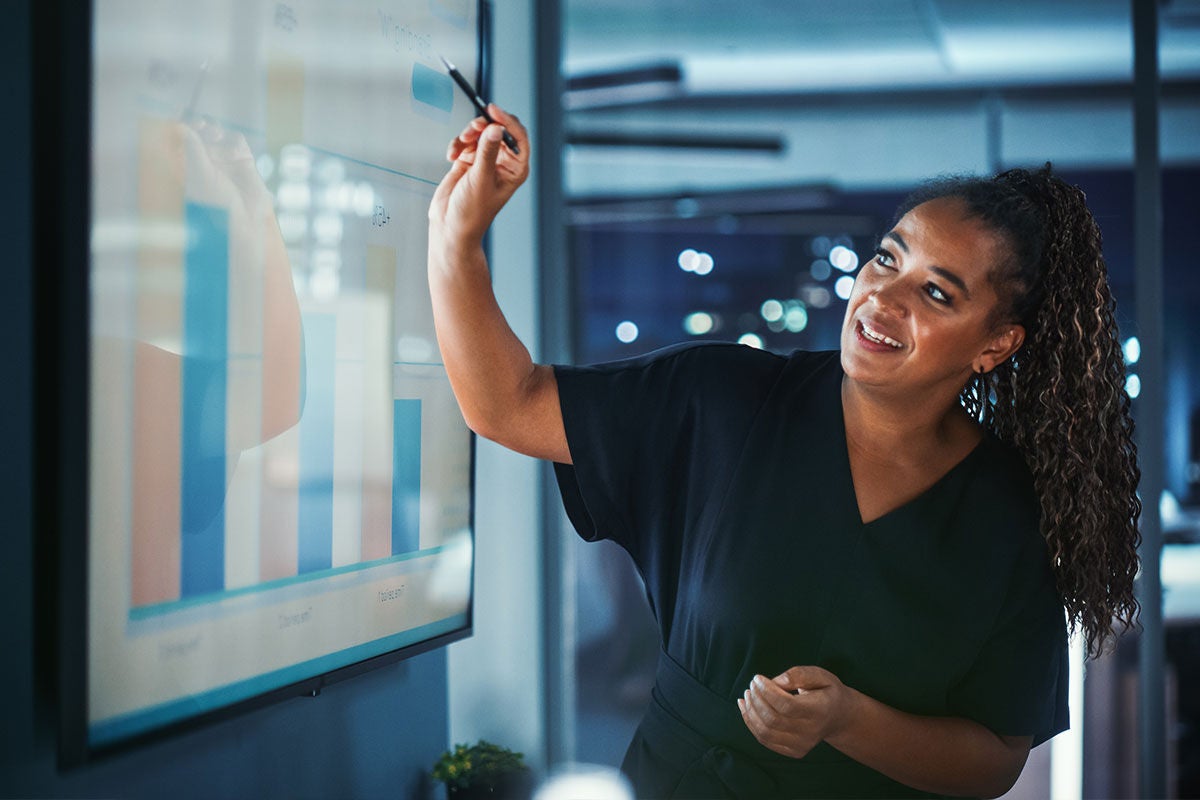 woman pointing to presentation in office